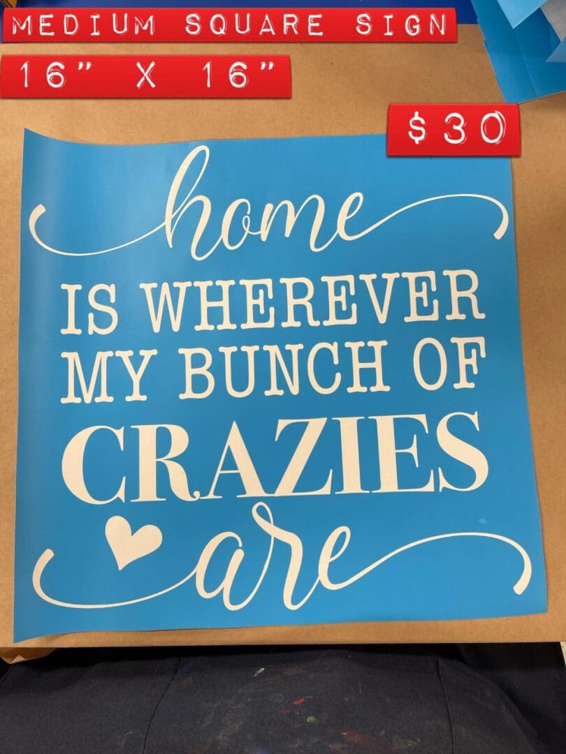 A blue sign that says home is wherever my bunch of crazies are.