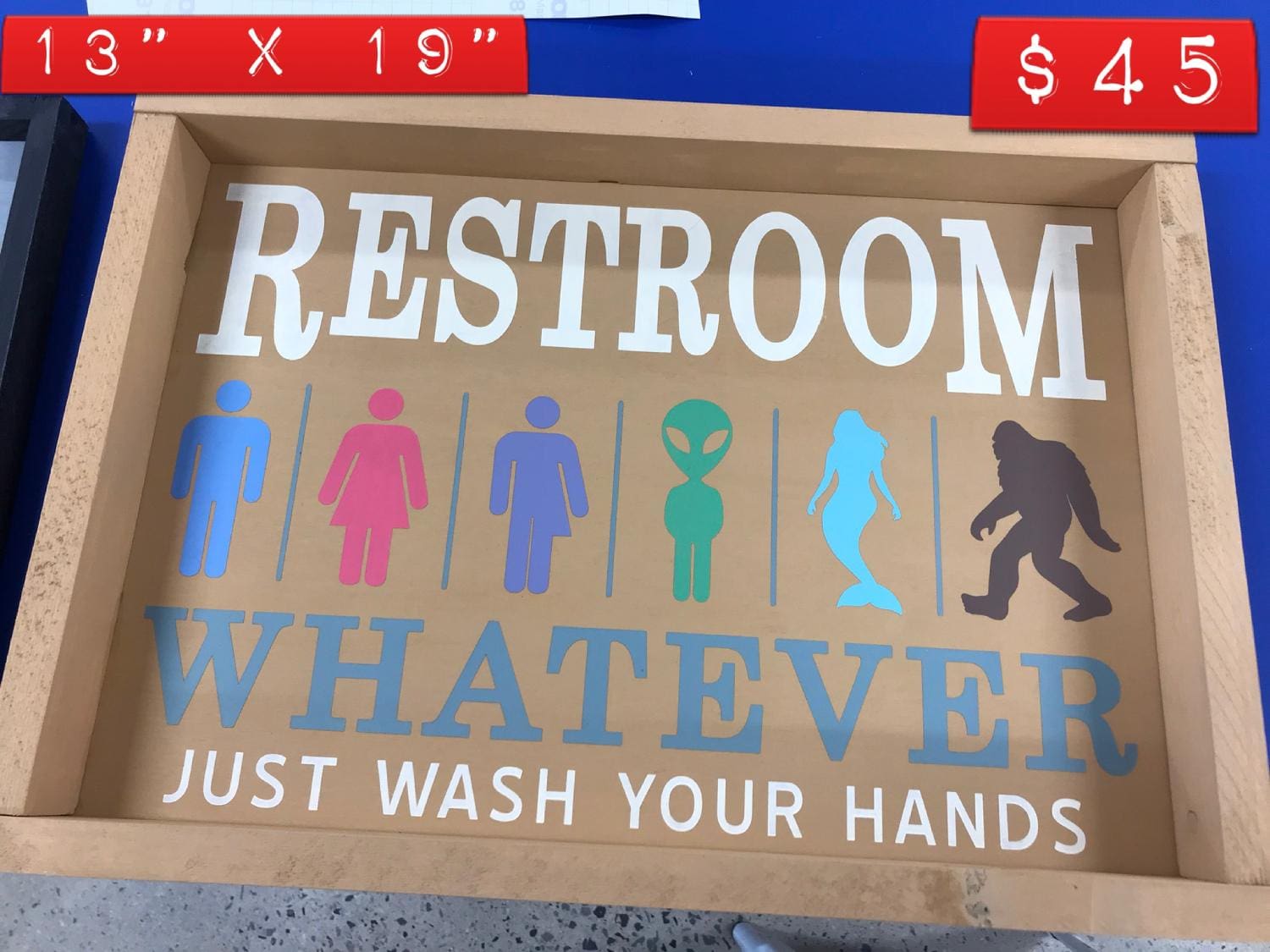 A sign that says restroom whatever just wash your hands.